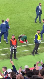Cristiano Ronaldo kneeling on the field after a penalty shootout.