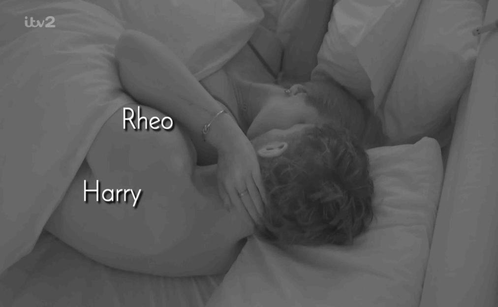 Black and white image of Rheo and Harry in bed.