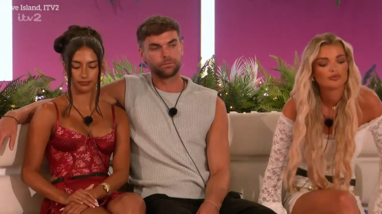 Three Love Island contestants sitting on a couch.