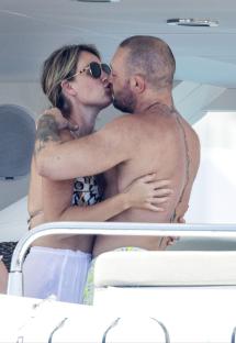 Conor McGregor and Dee Devlin kissing on a yacht.