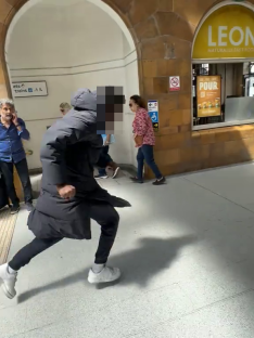 Man running at Earls Court Station.