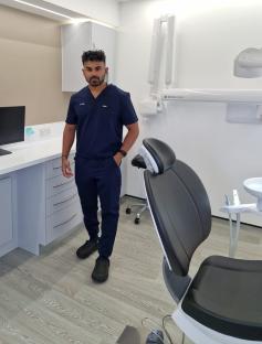A dentist standing in his dental office.