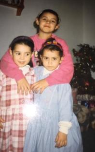 Three young girls posing for a photo.