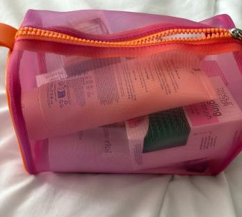 Mesh bag filled with beauty products.