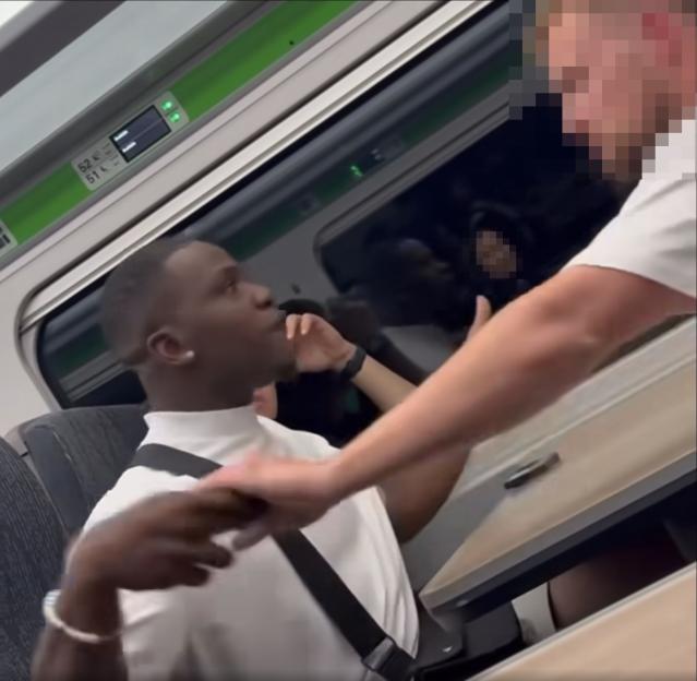 A man making threats to women on a train.
