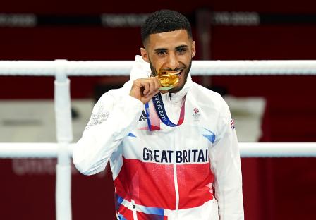 Galal Yafai, a British boxer, bites his gold medal at the Tokyo 2020 Olympics.