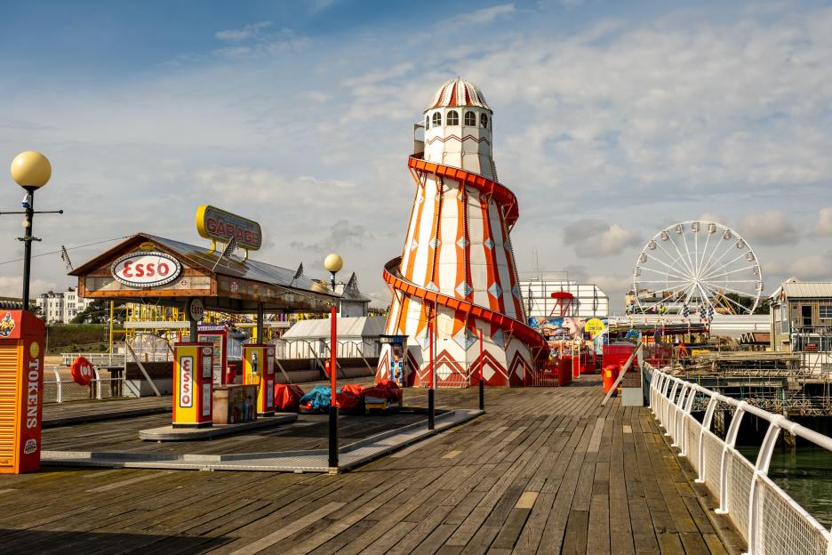 Funfair rides and games on a pier.