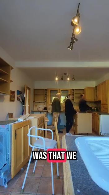 People assembling a kitchen in a home.