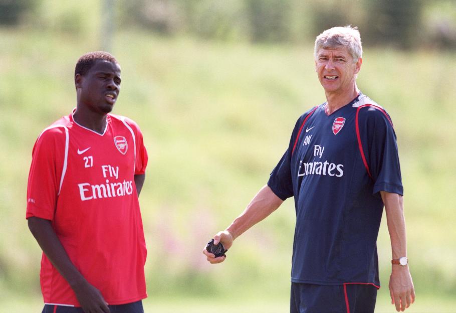 Arsene Wenger and Emmanuel Eboue at an Arsenal training session.