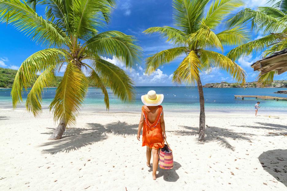 Woman walking on a tropical beach.
