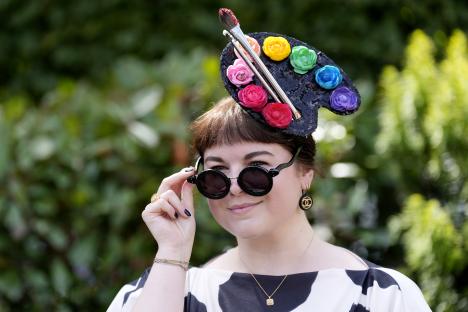 Woman at Royal Ascot wearing a hat shaped like a painter's palette.