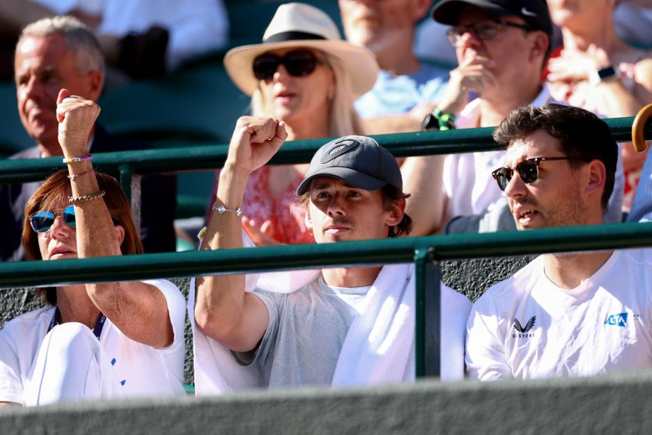 Alex De Minaur watching a Wimbledon match.
