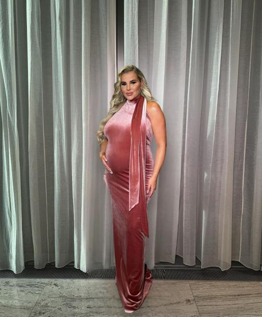 Pregnant Georgia Kousoulou in a pink velvet dress.