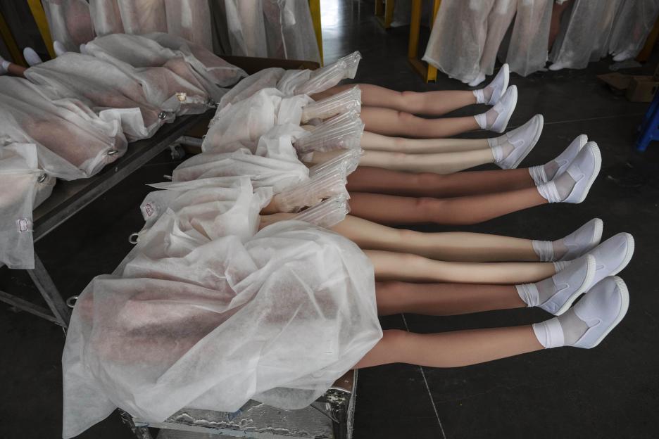 Legs of sex dolls in a factory awaiting packaging.