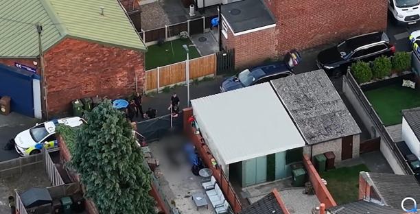 Aerial view of police officers at a crime scene.