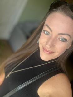 Portrait of a smiling woman with long brown hair.