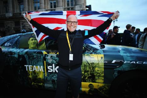 Team Sky manager celebrating Chris Froome's 2015 Tour de France victory.