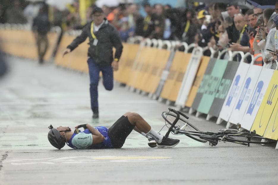 Cyclist lying on the ground after a crash near the finish line.