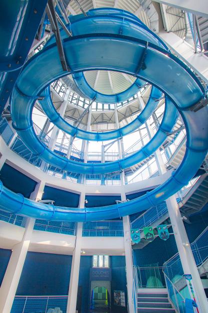 Interior view of a water park's spiral water slides.