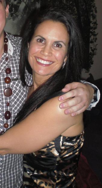 Woman hugging a man's shoulder.