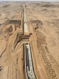 Aerial view of pipeline construction in a desert.