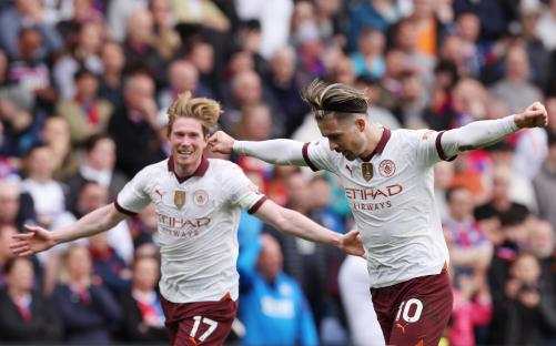 Manchester City's Kevin De Bruyne and Jack Grealish celebrating a goal.