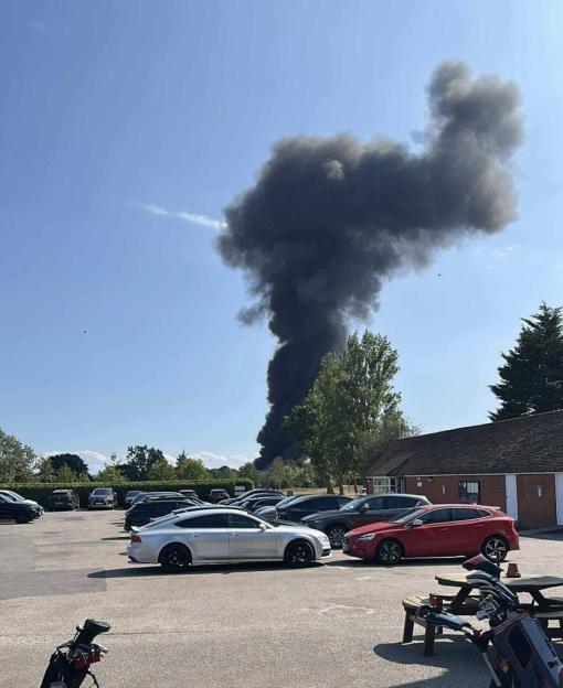 Large plume of black smoke rising from Southend Airport after a small plane crash.