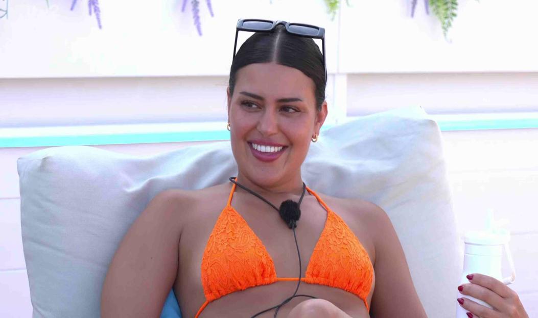 Woman in orange bikini smiling.