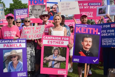 Protestors holding signs supporting assisted dying.