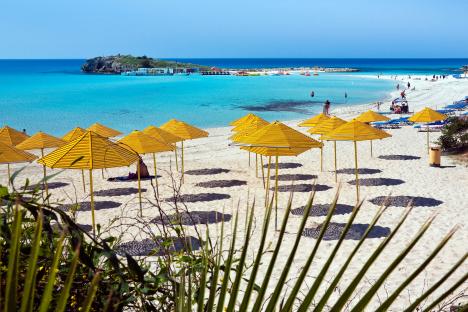 Yellow parasols on Nissi Beach in Cyprus.