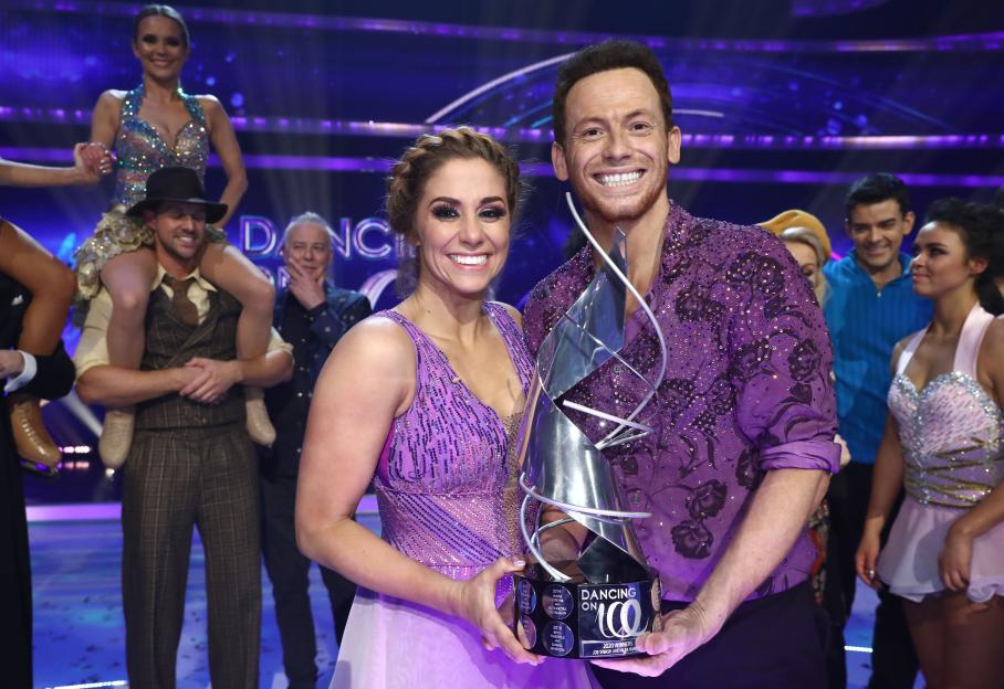 Joe Swash and Alex Murphy, winners of Dancing on Ice 2020, holding the trophy.