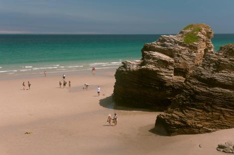 Beachgoers at Las Catedrales Beach in Ribadeo, Spain.