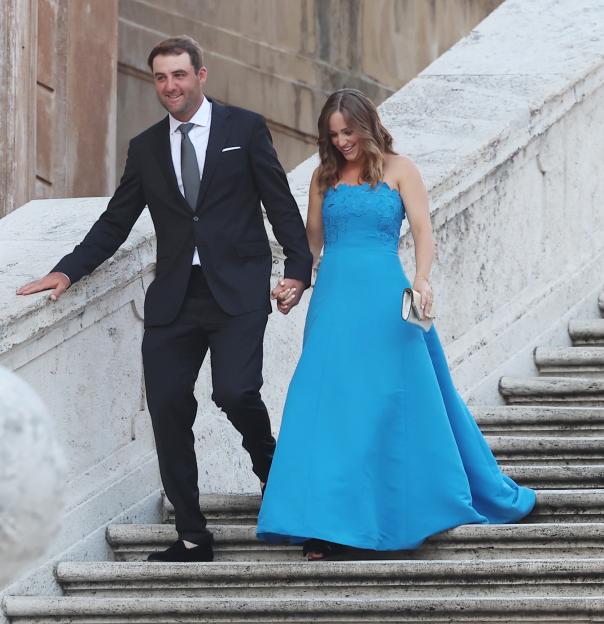 Scottie Scheffler and his wife Meredith Scudder walking down stairs.
