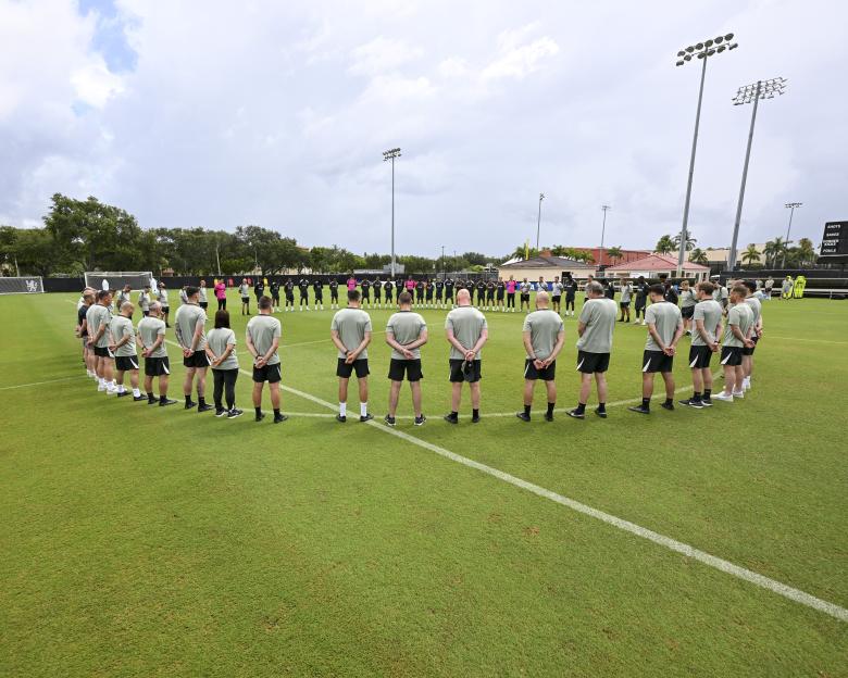 Chelsea players and staff observing a moment of silence.