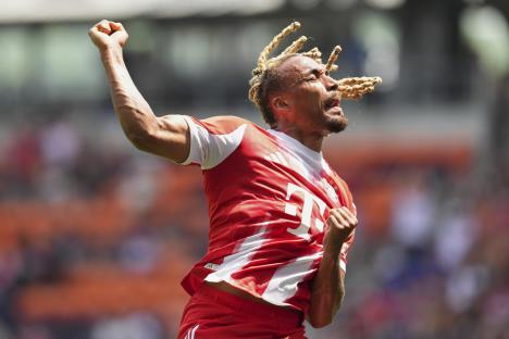Sacha Boey of Bayern Munich celebrating a goal.