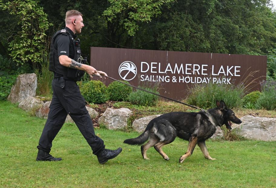 Police officer with sniffer dog at Delamere Lake Sailing & Holiday Park.