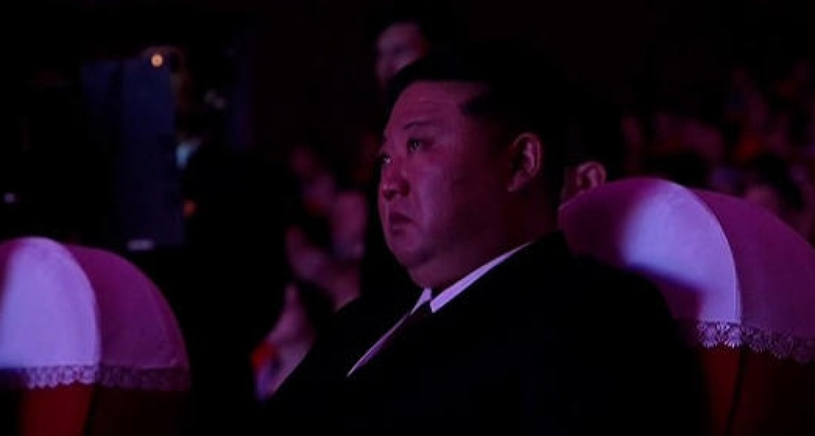 Kim Jong-un seated in an audience.