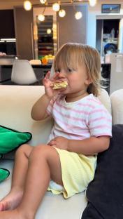 Toddler eating a snack.