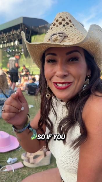 Woman in a straw cowboy hat at a music festival.