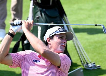 Golfer Will Chandler practicing at the driving range.