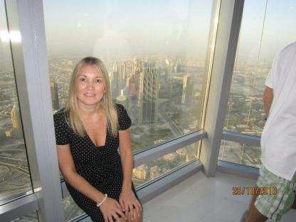 Woman in Dubai, overlooking the city from a skyscraper.