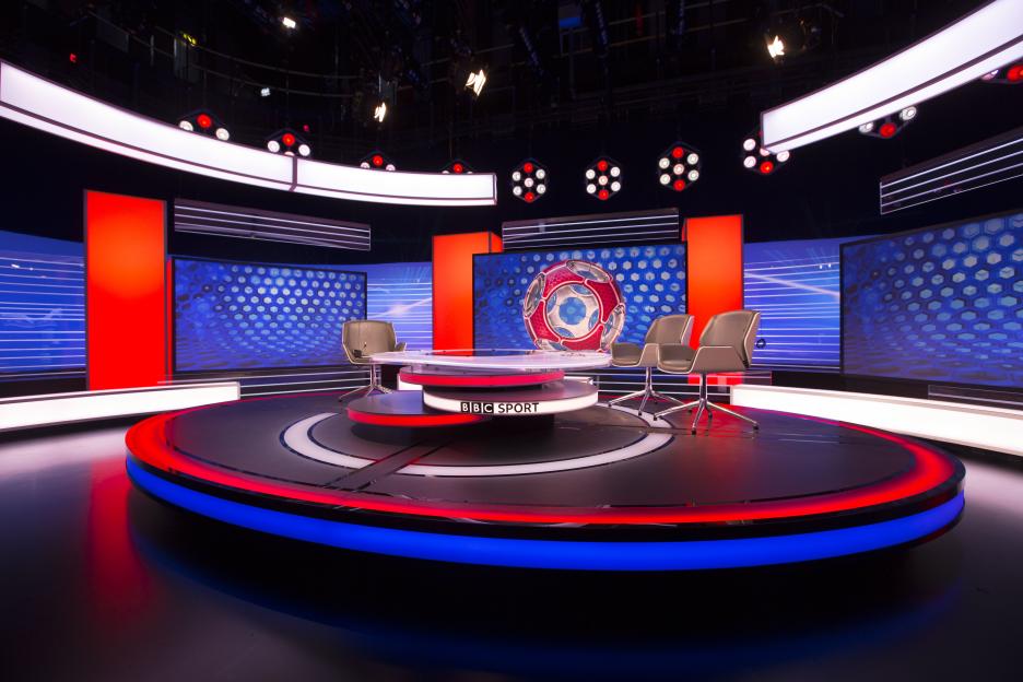 BBC Sport studio set with red and blue lighting.