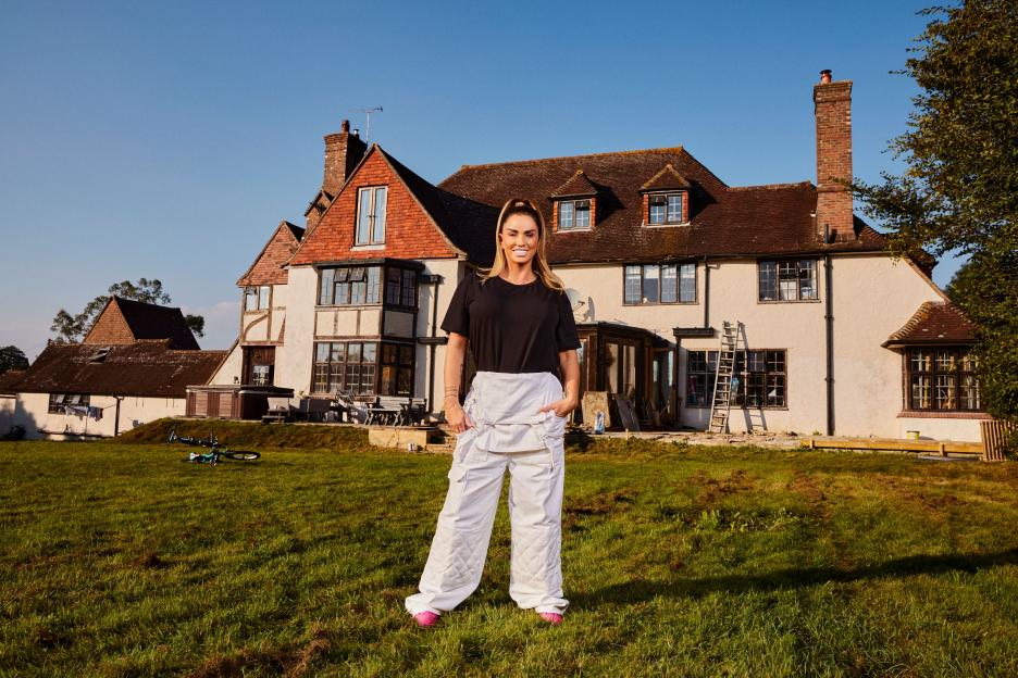 Katie Price standing in front of her house during renovations.