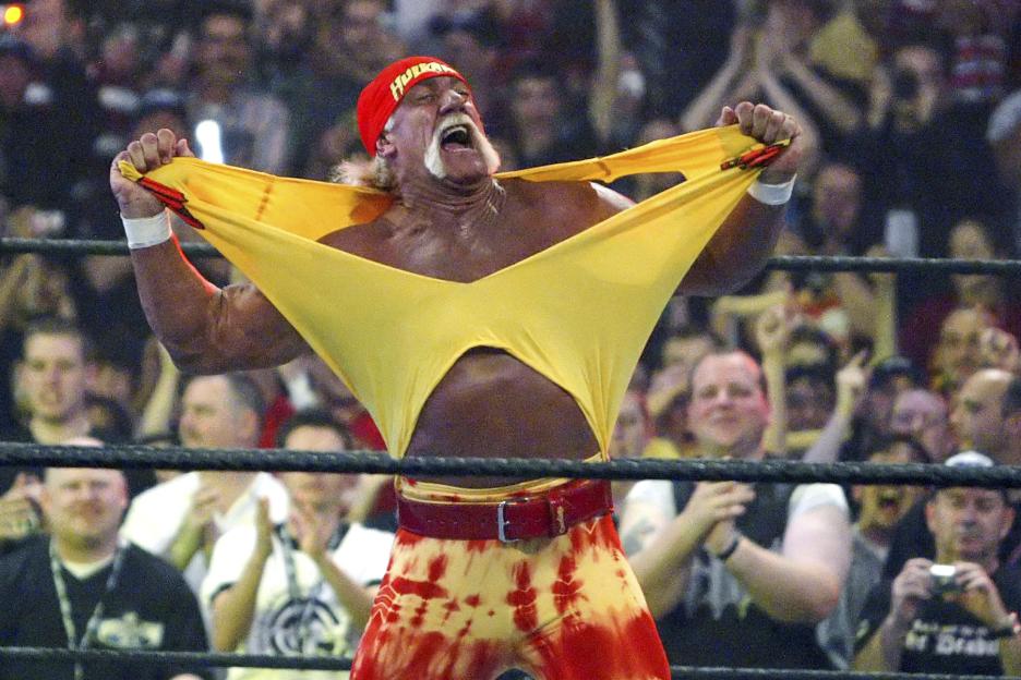 Hulk Hogan tearing his shirt in a wrestling match.