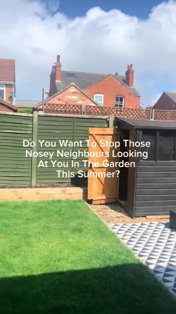 Back garden with a fence and shed, blocking neighbors' view.