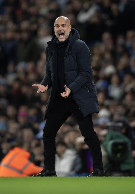 Pep Guardiola, Manchester City manager, coaching during a match.