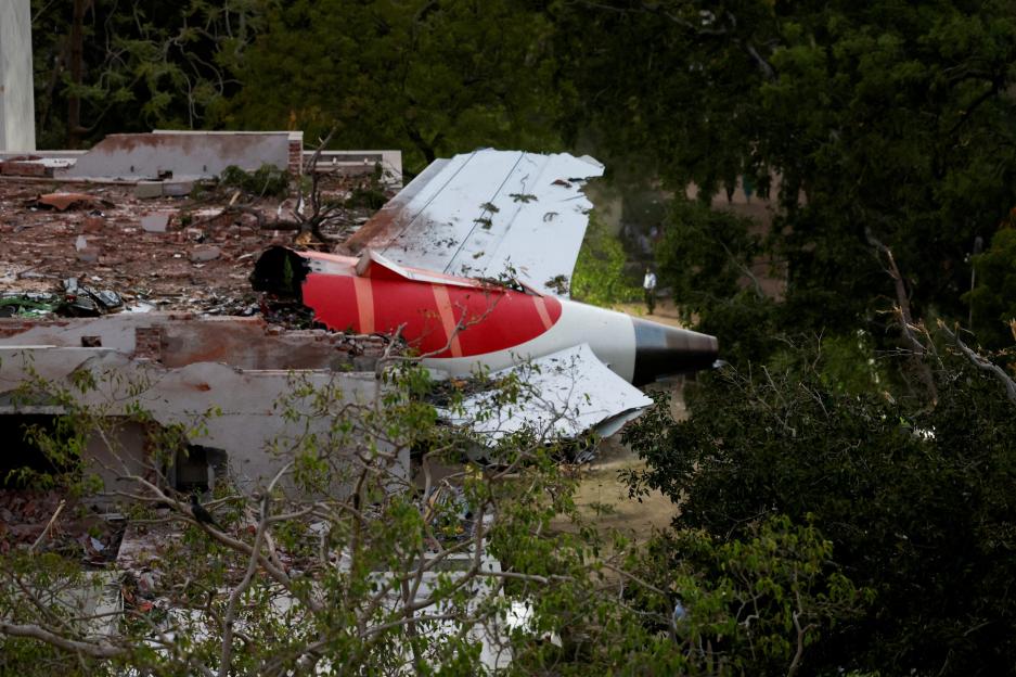 Debris of a plane's tail section embedded in a damaged building.
