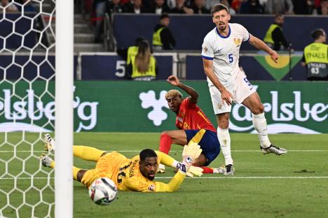 Soccer goalie diving to stop a goal during a match.