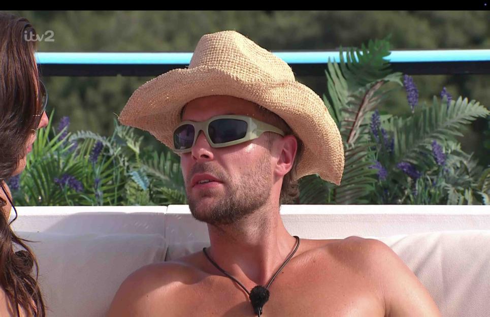 Man wearing a straw hat and sunglasses.