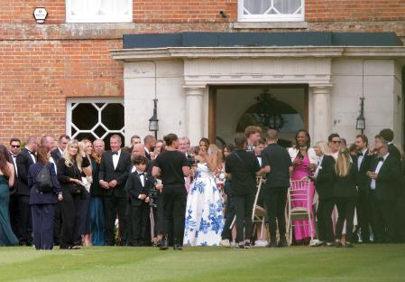 Wedding guests gathered outside a building.